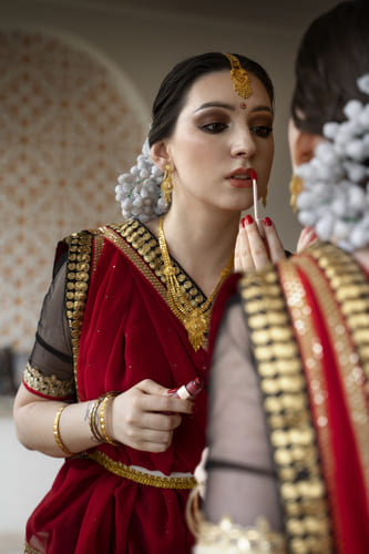 A bride getting ready at a unisex salon in Kolkata, showcasing bridal makeup services and professional grooming.