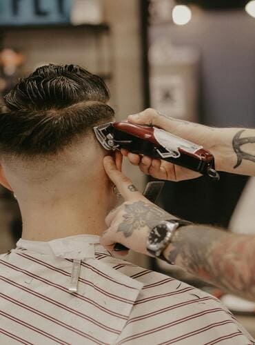 Man getting a haircut in a unisex salon.